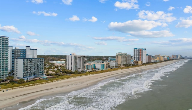 birds eye view of property with a water view and a view of the beach