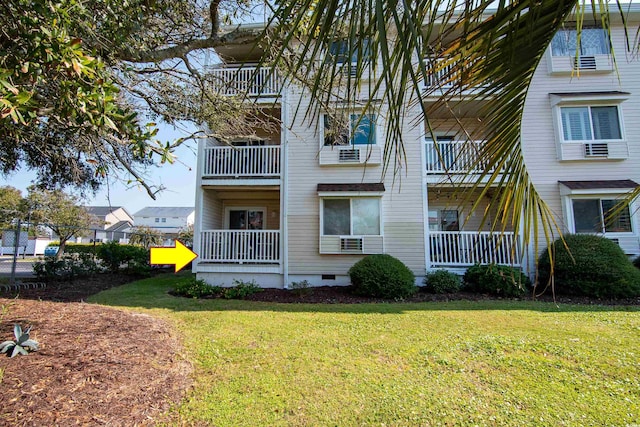 view of home's exterior with a lawn and a balcony