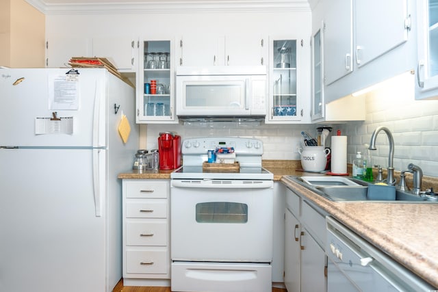 kitchen featuring white appliances, sink, white cabinets, crown molding, and decorative backsplash