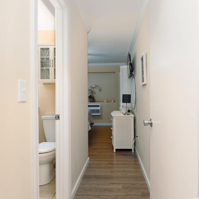 hall with baseboards, crown molding, a wall mounted AC, and wood finished floors