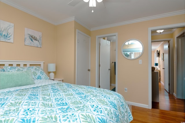 bedroom with ceiling fan, wood finished floors, baseboards, and ornamental molding