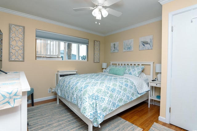 bedroom with a wall unit AC, ornamental molding, hardwood / wood-style flooring, and ceiling fan