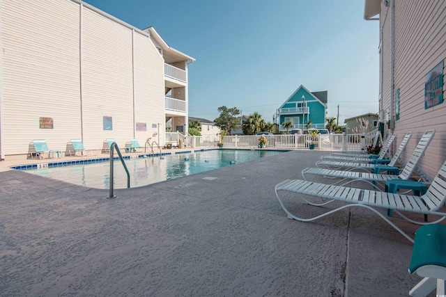 view of swimming pool with a patio