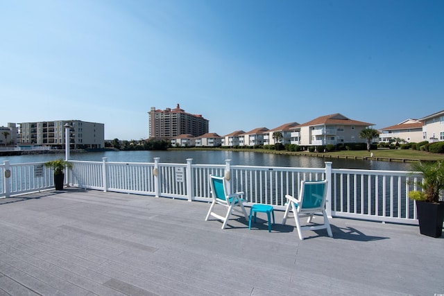 view of patio / terrace with a residential view and a deck with water view