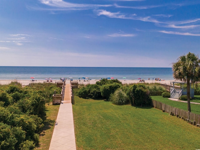 view of water feature featuring fence and a view of the beach