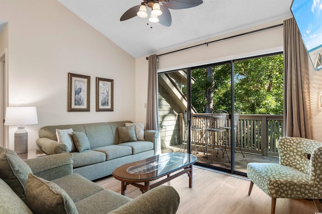 living room with lofted ceiling, light hardwood / wood-style flooring, and ceiling fan