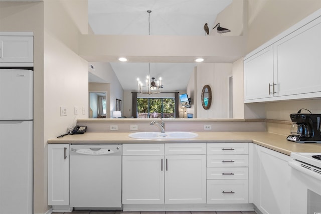 kitchen featuring pendant lighting, sink, white cabinets, a chandelier, and white appliances