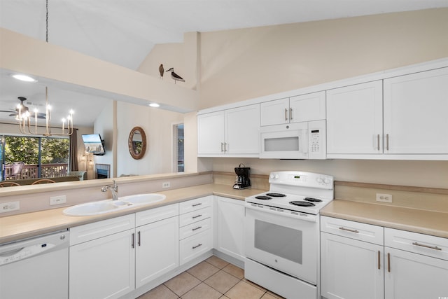 kitchen with sink, white cabinetry, vaulted ceiling, light tile patterned floors, and white appliances