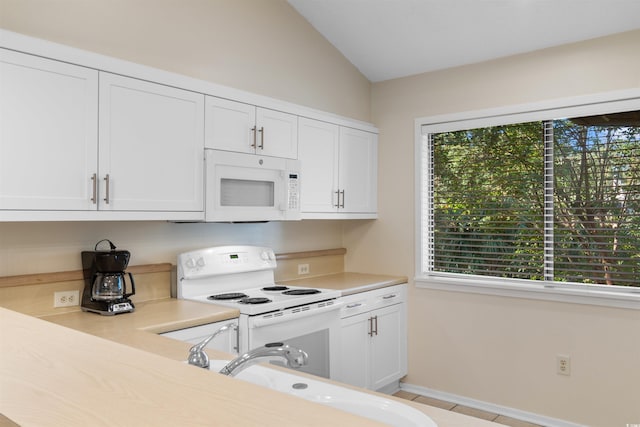 kitchen featuring white appliances, a wealth of natural light, sink, and white cabinets