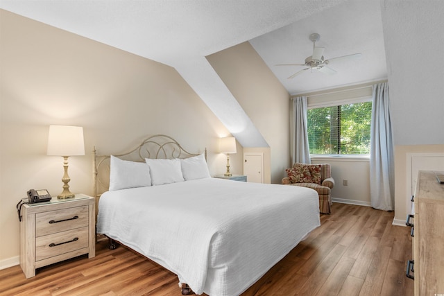 bedroom with vaulted ceiling, hardwood / wood-style floors, and ceiling fan