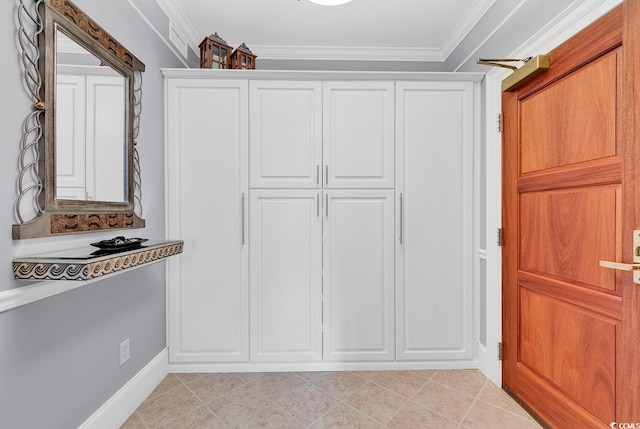 interior space with white cabinetry, crown molding, and light tile patterned flooring