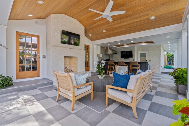 patio terrace at dusk featuring an outdoor living space and ceiling fan