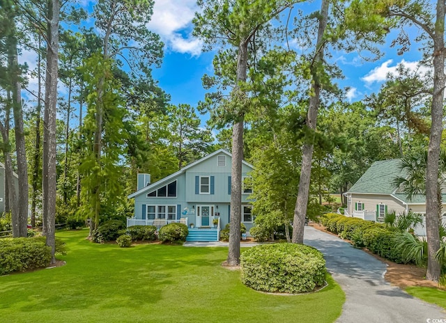 view of front of property with a porch and a front lawn