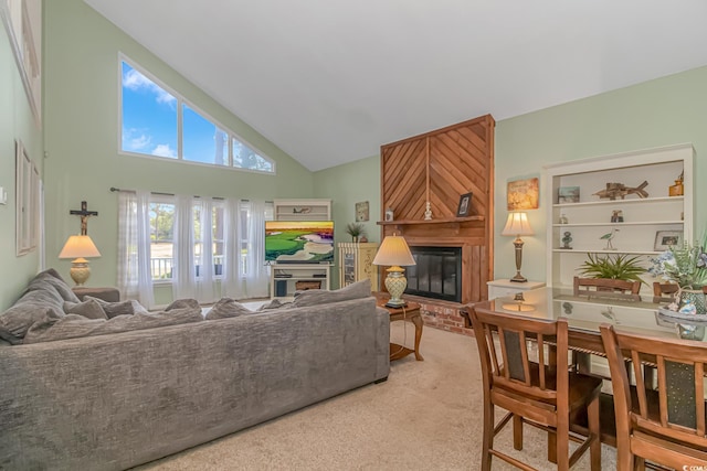 carpeted living room featuring a fireplace and high vaulted ceiling