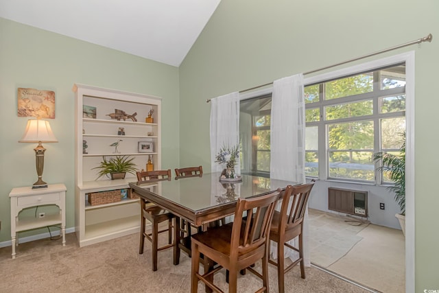 dining area featuring lofted ceiling and light colored carpet