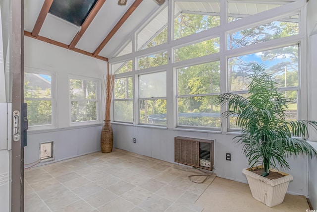 unfurnished sunroom featuring vaulted ceiling with beams