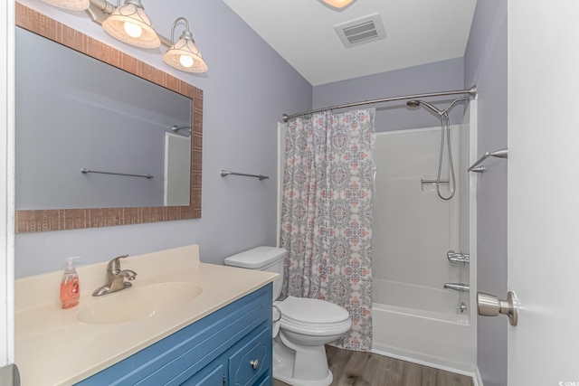 full bathroom featuring wood-type flooring, shower / tub combo with curtain, vanity, and toilet