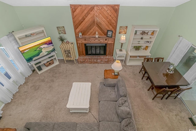 living room with a large fireplace and light carpet