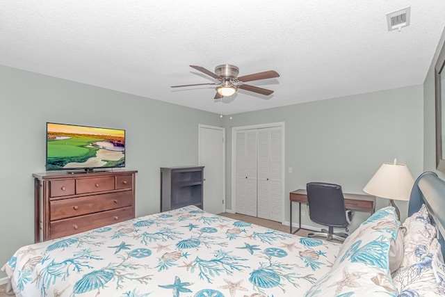 bedroom with a textured ceiling, ceiling fan, and a closet