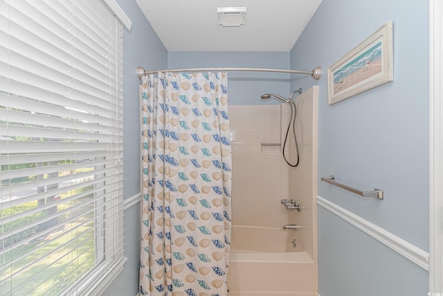 bathroom with shower / tub combo