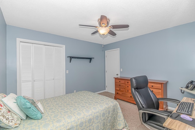 carpeted bedroom featuring a closet and ceiling fan