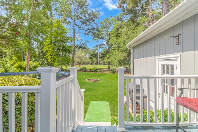 view of yard featuring an outdoor fire pit and a deck