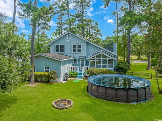 back of property featuring a sunroom and a lawn