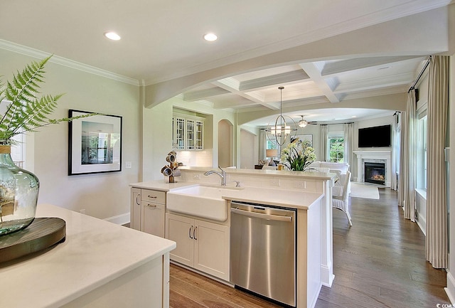 kitchen featuring sink, stainless steel dishwasher, an island with sink, light hardwood / wood-style flooring, and white cabinets