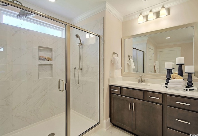 bathroom with vanity, an enclosed shower, and ornamental molding