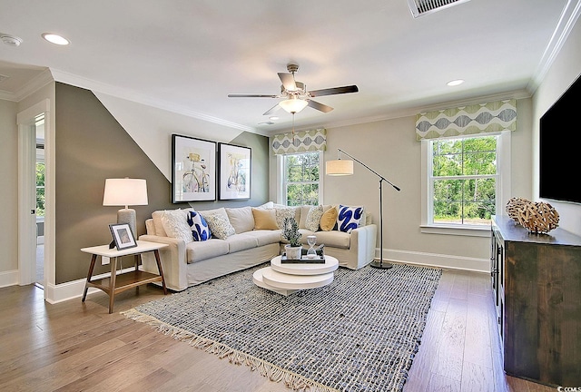 living room featuring light wood-type flooring, ceiling fan, and crown molding