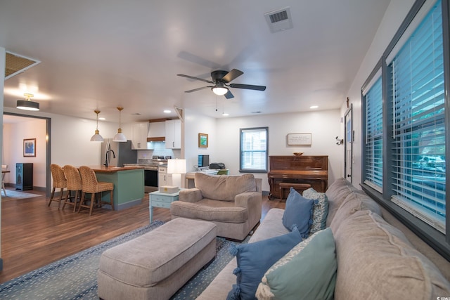 living room featuring ceiling fan and wood-type flooring