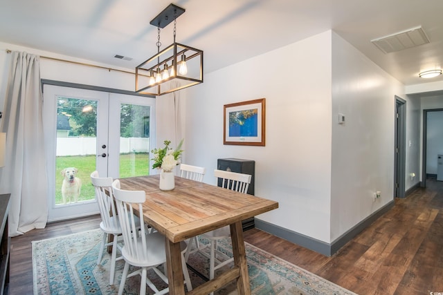 dining room featuring a notable chandelier, dark hardwood / wood-style flooring, and french doors