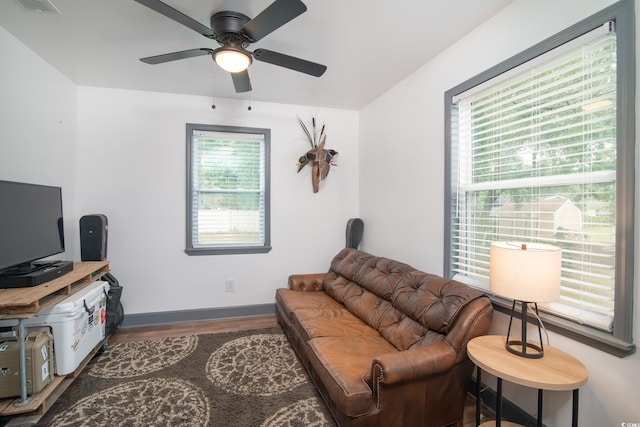 living room with hardwood / wood-style flooring, plenty of natural light, and ceiling fan