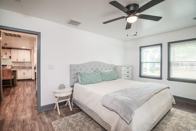 bedroom with dark hardwood / wood-style flooring and ceiling fan