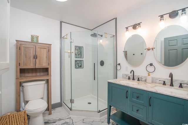 bathroom with vanity, toilet, and a shower with door