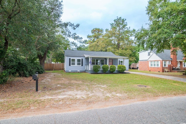 single story home with a porch and a front yard