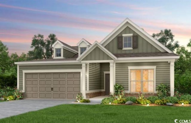 view of front of home featuring a garage and a yard