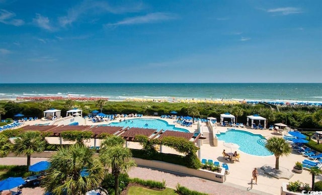 view of pool featuring a water view and a patio