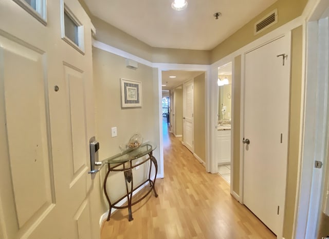 corridor with light hardwood / wood-style flooring