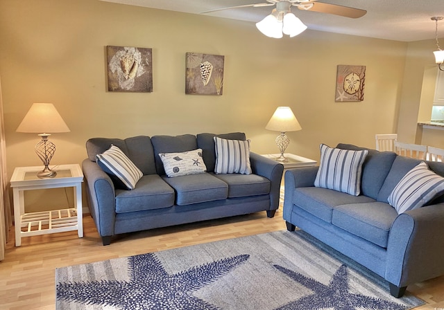 living room with hardwood / wood-style floors and ceiling fan