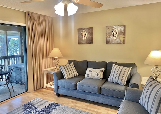 living room featuring hardwood / wood-style flooring and ceiling fan