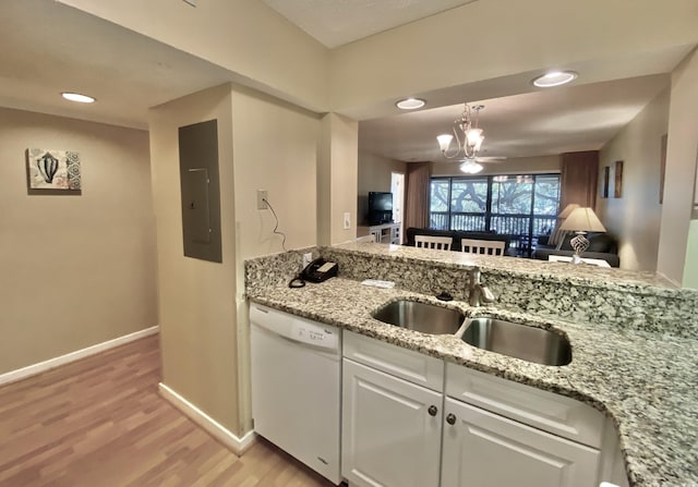 kitchen featuring sink, electric panel, white dishwasher, white cabinets, and light wood-type flooring