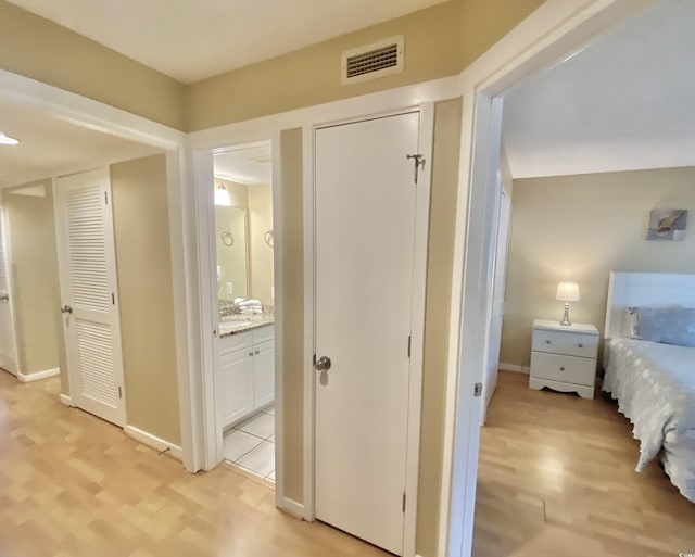 hallway with light hardwood / wood-style flooring