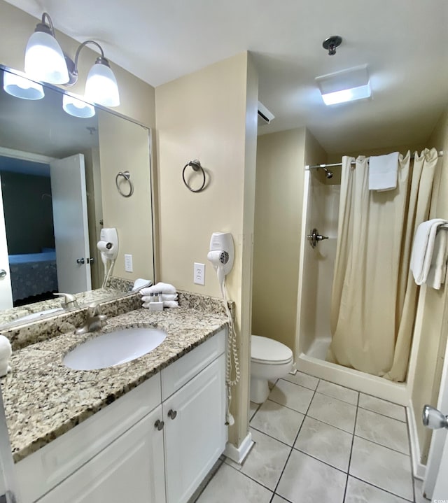 bathroom featuring vanity, a shower with curtain, tile patterned floors, and toilet