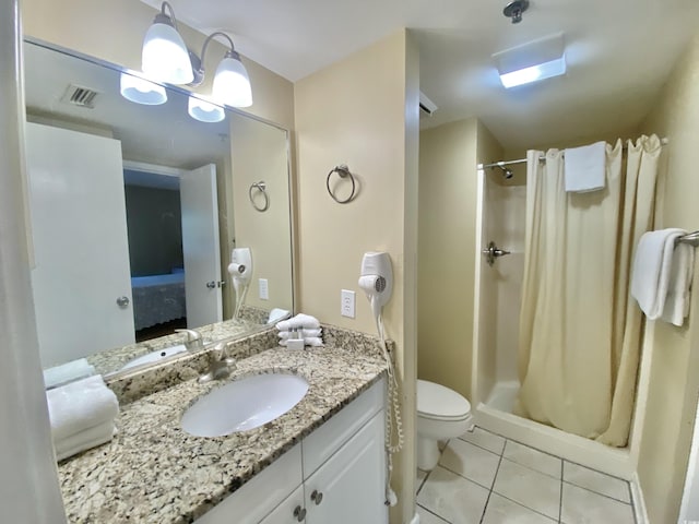 bathroom with a shower with curtain, vanity, tile patterned floors, and toilet