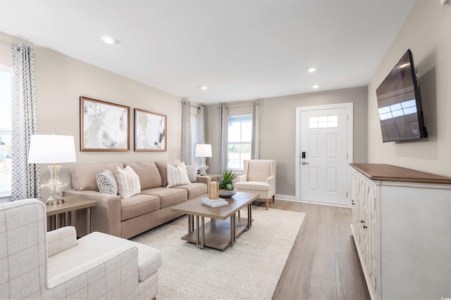 living area with light wood finished floors, baseboards, and recessed lighting