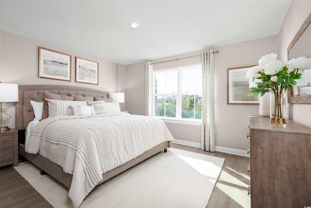 bedroom featuring wood finished floors, baseboards, and recessed lighting