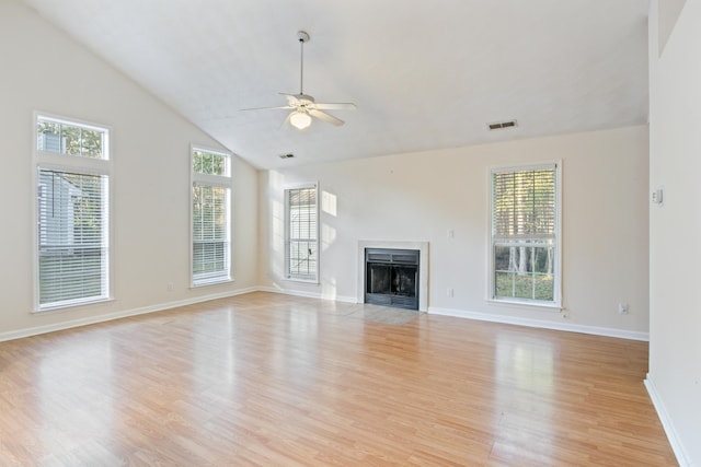 unfurnished living room featuring ceiling fan, a healthy amount of sunlight, and light wood-type flooring