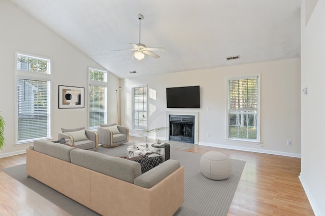 living room with high vaulted ceiling, light hardwood / wood-style floors, and ceiling fan