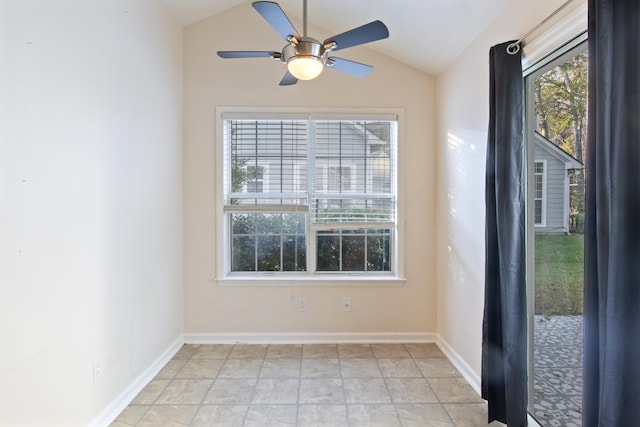 empty room featuring ceiling fan and vaulted ceiling